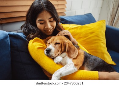 Happy asian woman enjoying her dog pet in the home, Friendship pet and human lifestyle concept. - Powered by Shutterstock