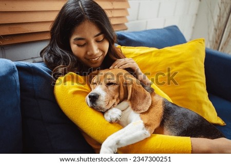 Happy asian woman enjoying her dog pet in the home, Friendship pet and human lifestyle concept.