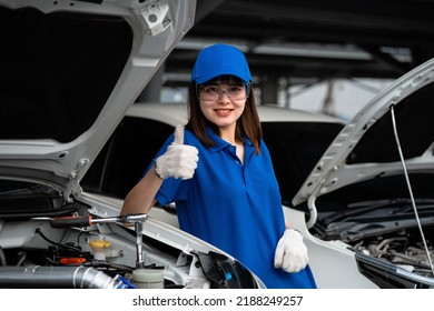 Happy Asian Woman Expert Repairman Auto Mechanic In Car Service In Auto Garage. Car Maintenance Concept. Auto Mechanic. Auto Mechanic.