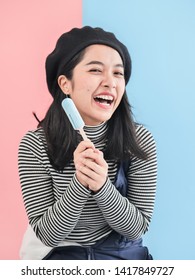 Happy Asian Woman Holding Blue Ice Cream Stick With Color Background.