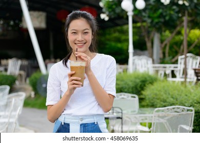 Happy Asian Woman Holding Ice Coffee Outdoors