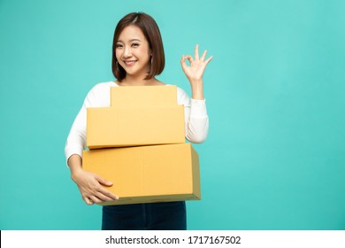 Happy Asian Woman Holding Package Parcel Box And And Showing Ok, Delivery Courier And Shipping Service Concept