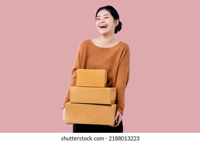 Happy Asian Woman Holding Parcel Box Isolated Over Pink Background.