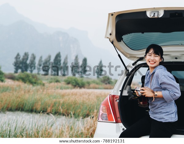 Happy\
Asian woman joyful with travel on her\
vacation.