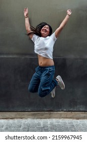 Happy Asian Woman Jumping In The Street