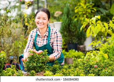 Happy Asian Woman Looking At Camera In The Garden