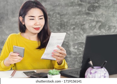  Happy Asian Woman Paying For Electricity Bill By Smart Phone 