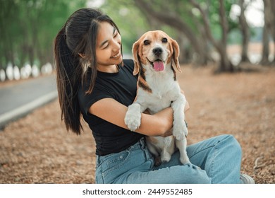 Happy asian woman playing with dog together in public park outdoors, Friendship between human and their pet - Powered by Shutterstock