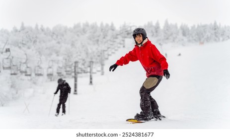 Happy Asian woman practice downhill sliding snowboard on snow mountain at ski resort. Attractive girl enjoy outdoor active lifestyle travel nature and winter extreme sport training on holiday vacation - Powered by Shutterstock