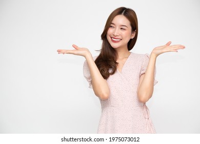 Happy Asian woman presenting or showing open hand palm with copy space for product isolated on white background