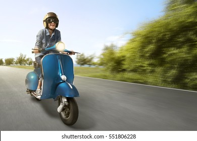 Happy Asian Woman Riding Scooter With High Speed On The Street