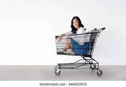 happy asian woman with shopping cart ready for shopping on sale season - Beautiful casual shopper girl going to the store.