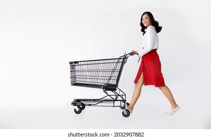 happy Asian woman shopping with a shopping cart on white isolated background for present sell and buy a business concept
