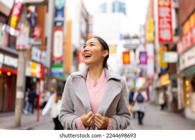 Happy Asian woman shopping and crossing street crosswalk with crowd of people at Shibuya, Tokyo, Japan in autumn. Attractive girl  enjoy and fun outdoor lifestyle travel in city on holiday vacation. - Powered by Shutterstock