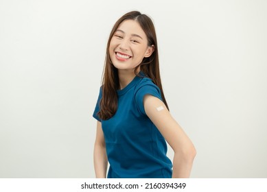 Happy Asian Woman Showing His Arm And Bandage After They Get A Vaccine.