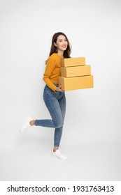 Happy Asian Woman Smiling And Holding Package Parcel Box Isolated On White Background, Delivery Courier And Shipping Service Concept, Full Length People Composition