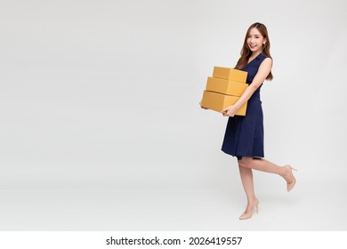 Happy Asian Woman Smiling And Holding Package Parcel Box Isolated On White Background, Delivery Courier And Shipping Service Concept, Full Body Composition