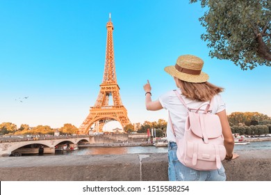 Happy Asian Woman Student With Backpack Observing View Of The Eiffel Tower In Paris. Travel And Education In France Concept