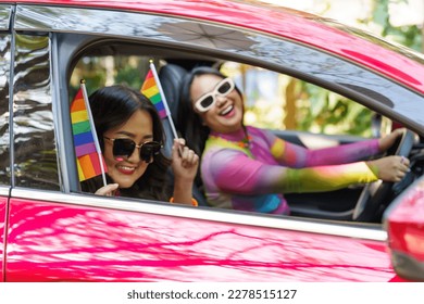 Happy Asian woman support LGBT pride parade in car. with Rainbow of LGBTQ or LGBTQIA  - Powered by Shutterstock