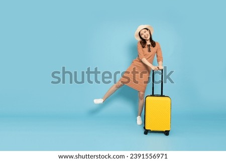 Happy Asian woman traveler standing with suitcase isolated on pink background, Tourist girl having cheerful holiday trip concept, Full body composition