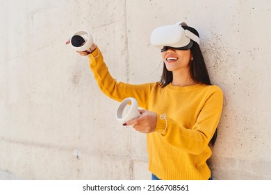 Happy Asian Woman Using Metaverse VR Set