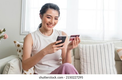 Happy Asian Woman Using Smartphone Shopping Online With Credit Card.  Lifestyle. Easy Pay Using Smart Phone Or Digital Device. 