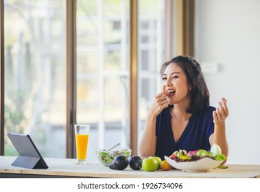 Happy Asian woman vegetarian healthy eating salad food and use tablet on the table. Young woman vegetarian. Vegetables and fruits. Vegan food. - Shutterstock ID 1926734096
