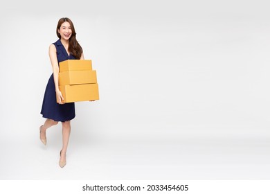 Happy Asian woman walking and holding package parcel box isolated on white background, Delivery courier and shipping service concept