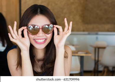 Happy Asian Woman Wearing Heart Shape Sun Glasses