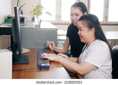 Happy Asian Women Co-workers In Office Workplace Including Person With Blindness Disability Using Computer With Refreshable Braille Display Assistive Device. Disability Inclusion At Work Concepts.