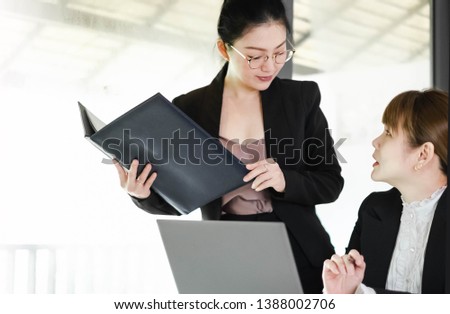 Happy Asian workingwomen working together at computer laptop. The successful businesswomen learning about e-commerce/e business as online technology is changing. Teamwork& collaboration concept.