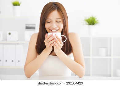 Happy Asian Young Drinking Coffee