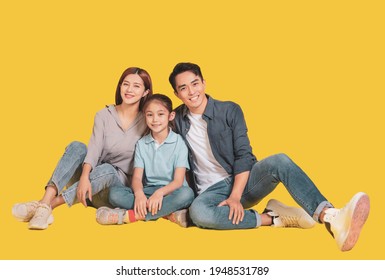 Happy Asian young family with one child sitting  and smiling at camera 