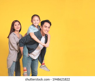 Happy Asian Young Family With One Child Standing Embracing And Smiling 