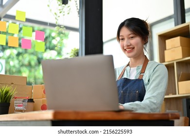 Happy Asian Young Female Fashion Shop Owner Using Laptop Computer To Reply Message From Her Customer, Getting A Good Review From Customer. Small Business Concept