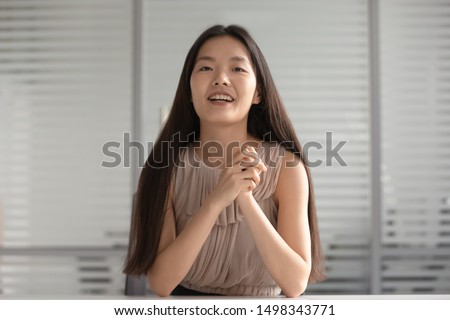 Happy asian young girl presenting herself at distant job interview. Smiling korean professional language teacher giving lesson to client, communicating via video call, recording educational lecture.