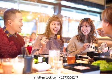 Happy Asian Young Group  Eating In The Restaurant