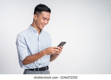 Happy Asian Young Man Looking At The Screen Of A Mobile Phone