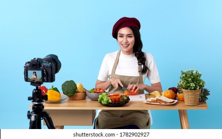 Happy asian young woman in fashion look style and shooting video with camera cooking food healthy is blogger presenting for social people.Her is influencer in social online. - Powered by Shutterstock