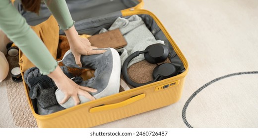 Happy Asian young woman packing suitcase at home. Preparing for summer holiday vacation abroad travel. - Powered by Shutterstock