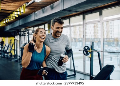 Happy athletic couple laughing while walking through the gym. Copy space. - Powered by Shutterstock