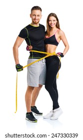 Happy athletic couple - man and woman with measuring tape on the white background