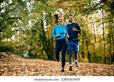 Happy athletic friends running while exercising in nature during autumn. Copy space.  - Powered by Shutterstock