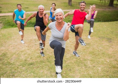 Happy athletic group training on a sunny day - Powered by Shutterstock