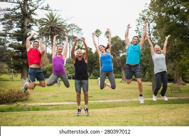 Happy athletic jumping together on a sunny day - Powered by Shutterstock