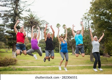 Happy athletic jumping together on a sunny day - Powered by Shutterstock