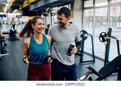 Happy athletic woman and her boyfriend exercising in health club. - Powered by Shutterstock