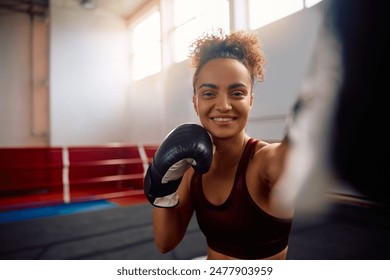 Happy athletic woman practicing boxing in health club and looking at camera. Copy space.  - Powered by Shutterstock