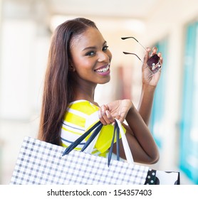 Happy Attractive African Shopper In Shopping Mall