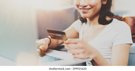 Happy Attractive Asian Woman Using Laptop And Golden Creditcard For Online Shopping From Home.Blurred Background,flares Effect. Wide